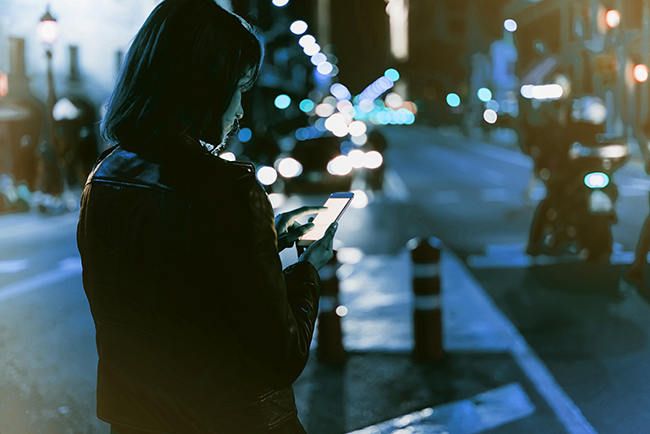 Woman-phone-night-time Woman using her phone at night.