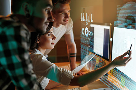 home-technology Tech workers looking at screens with data.