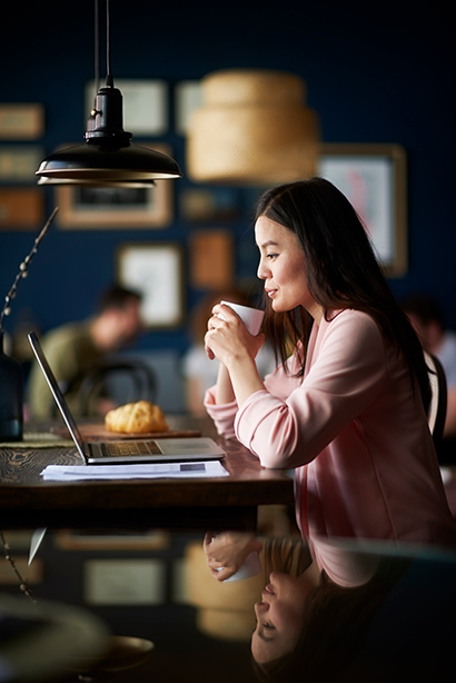 asian-woman-in-coffee-shop-having-a-coffee Young asian woman in coffee shop having a coffee.